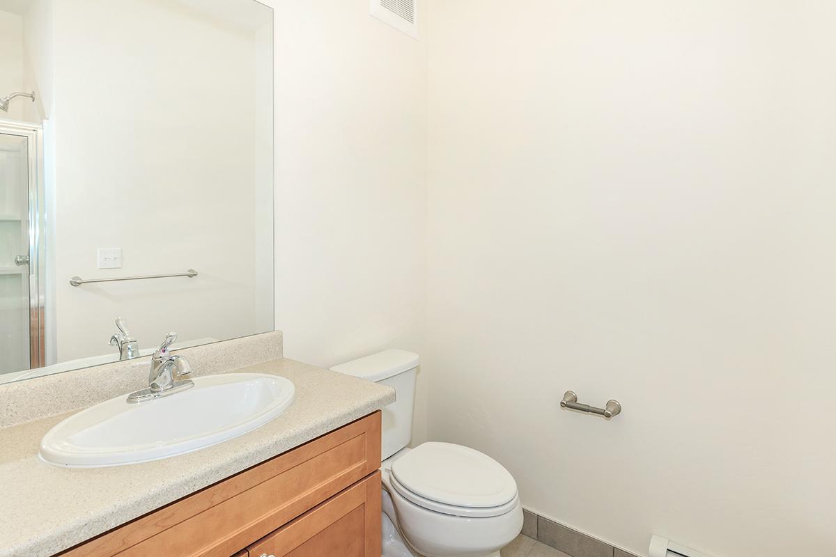 a white sink sitting next to a shower