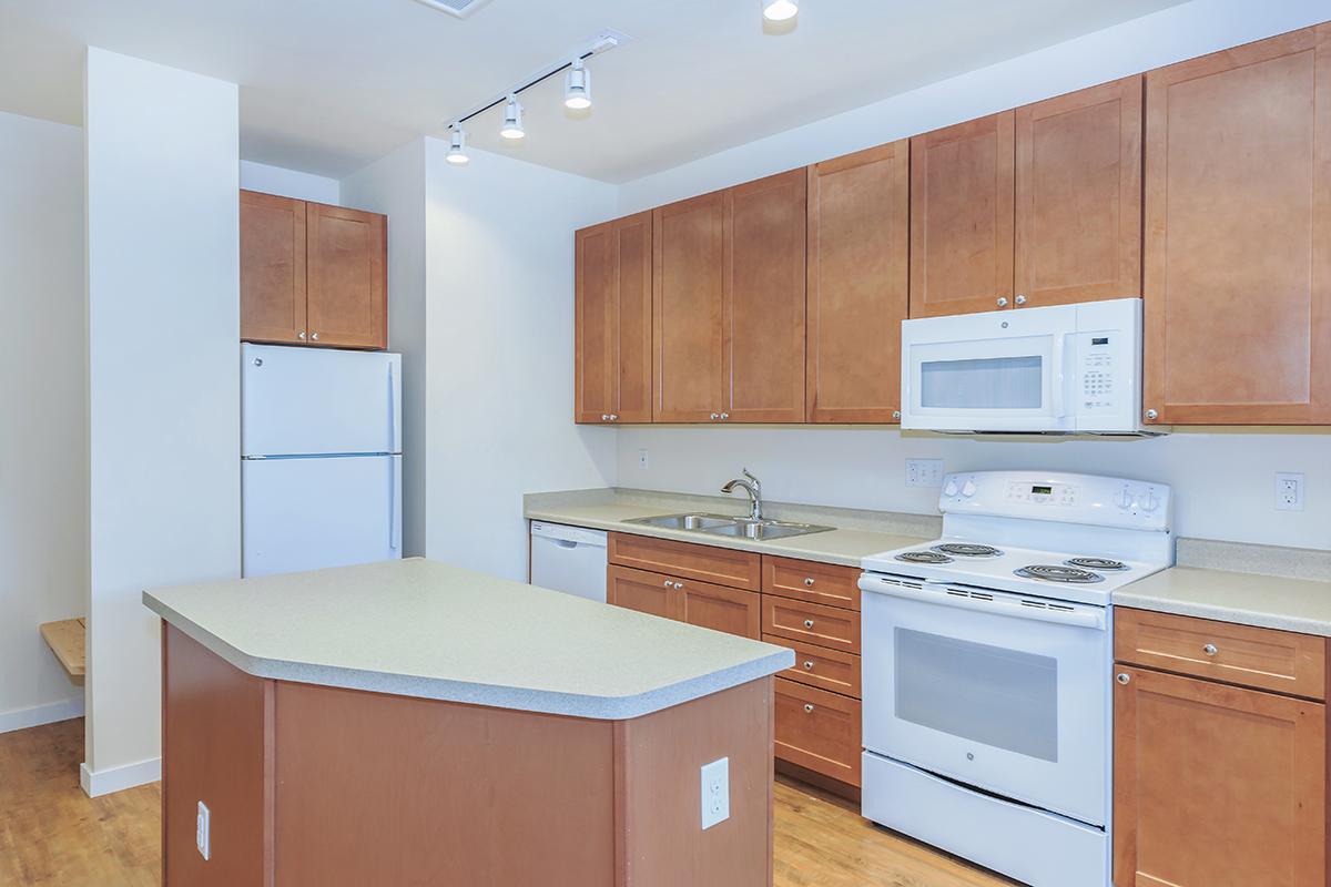 a kitchen with wooden cabinets and a microwave