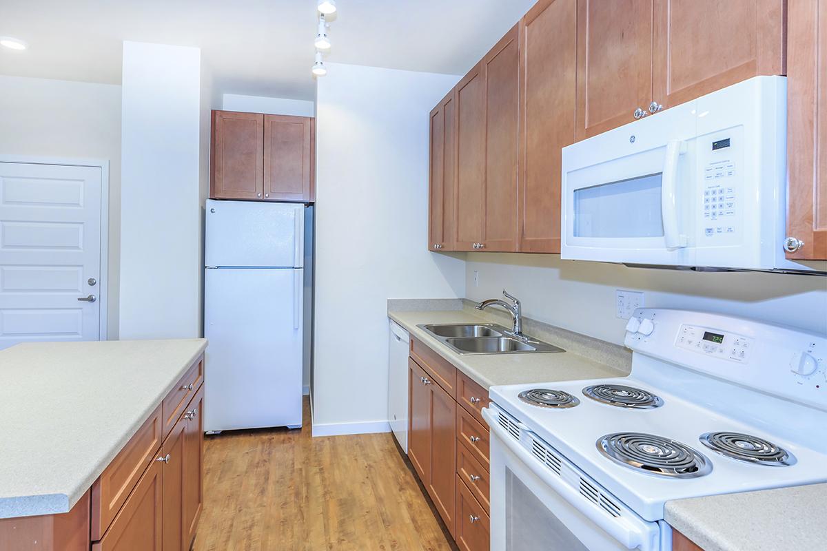 a white stove top oven sitting inside of a kitchen