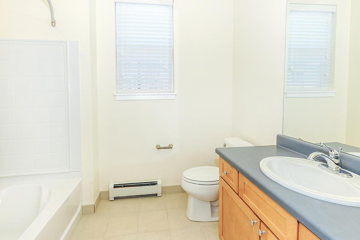 a white tub sitting next to a sink