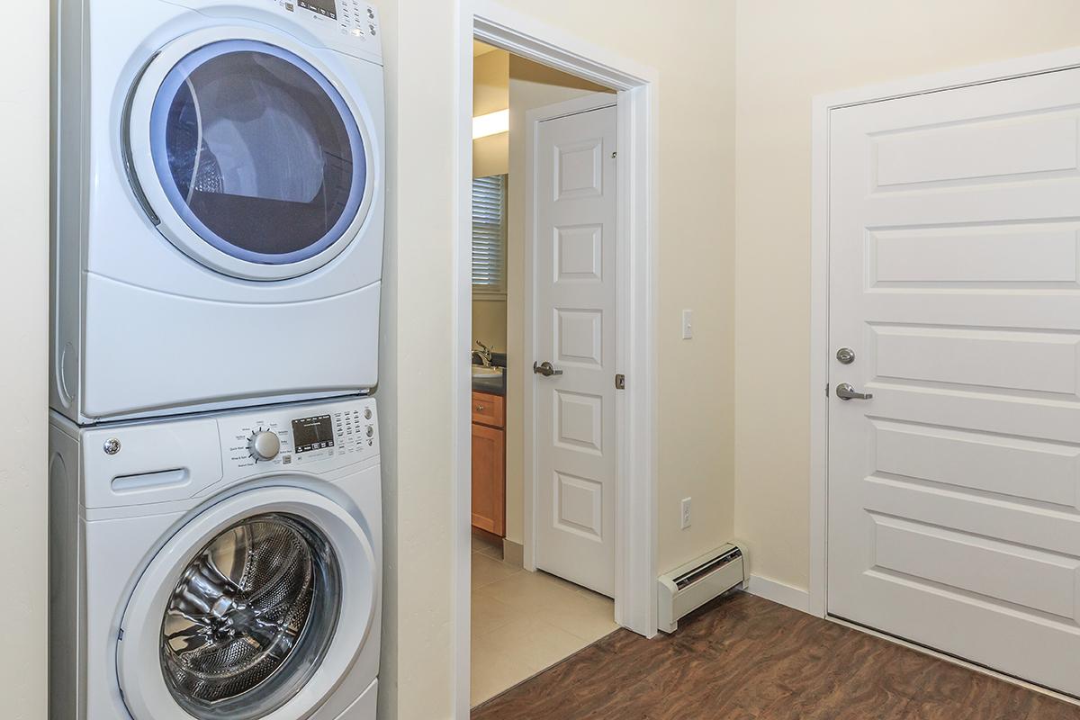 a kitchen with white cabinets and a mirror