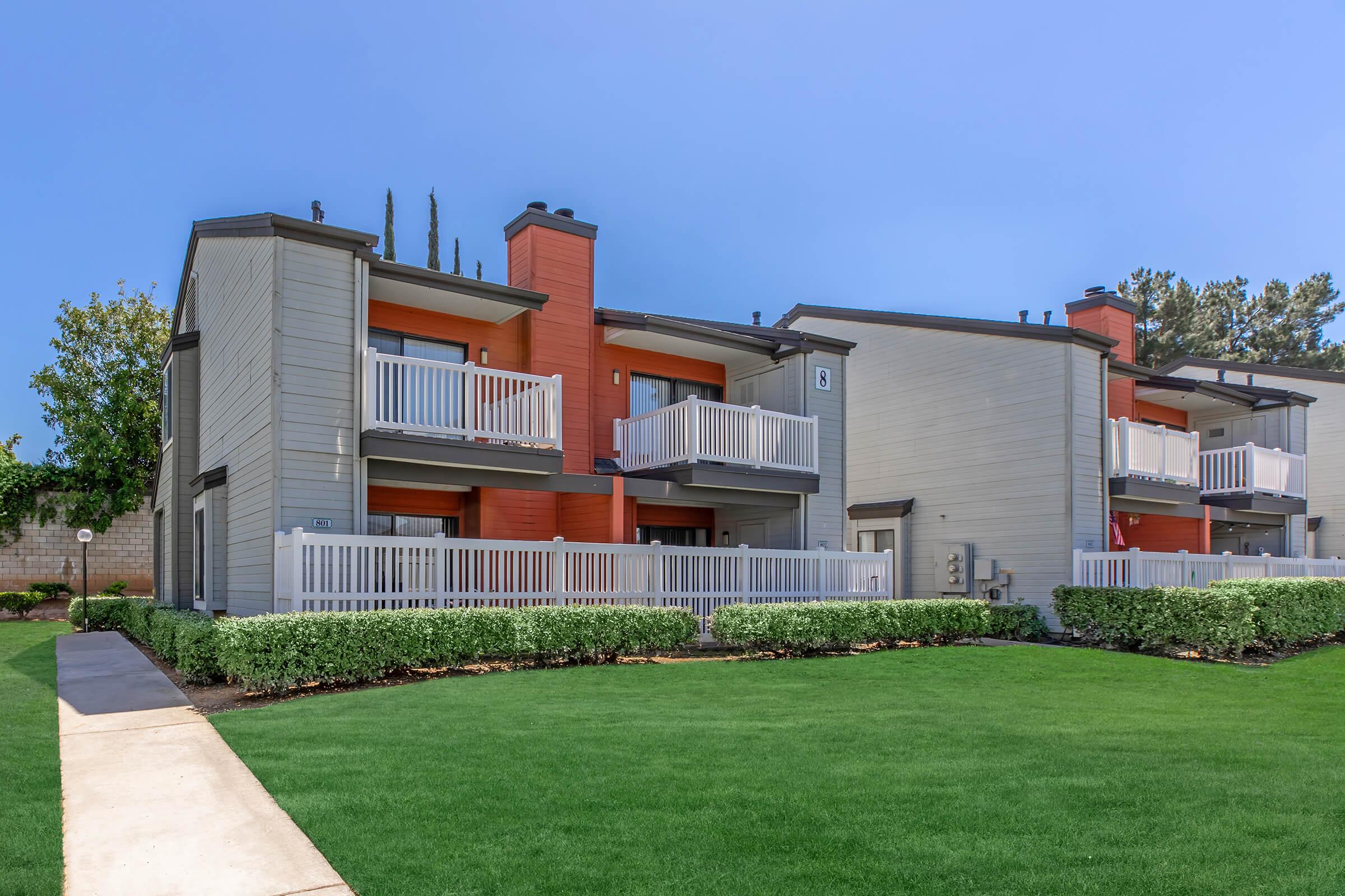 a large lawn in front of a brick building