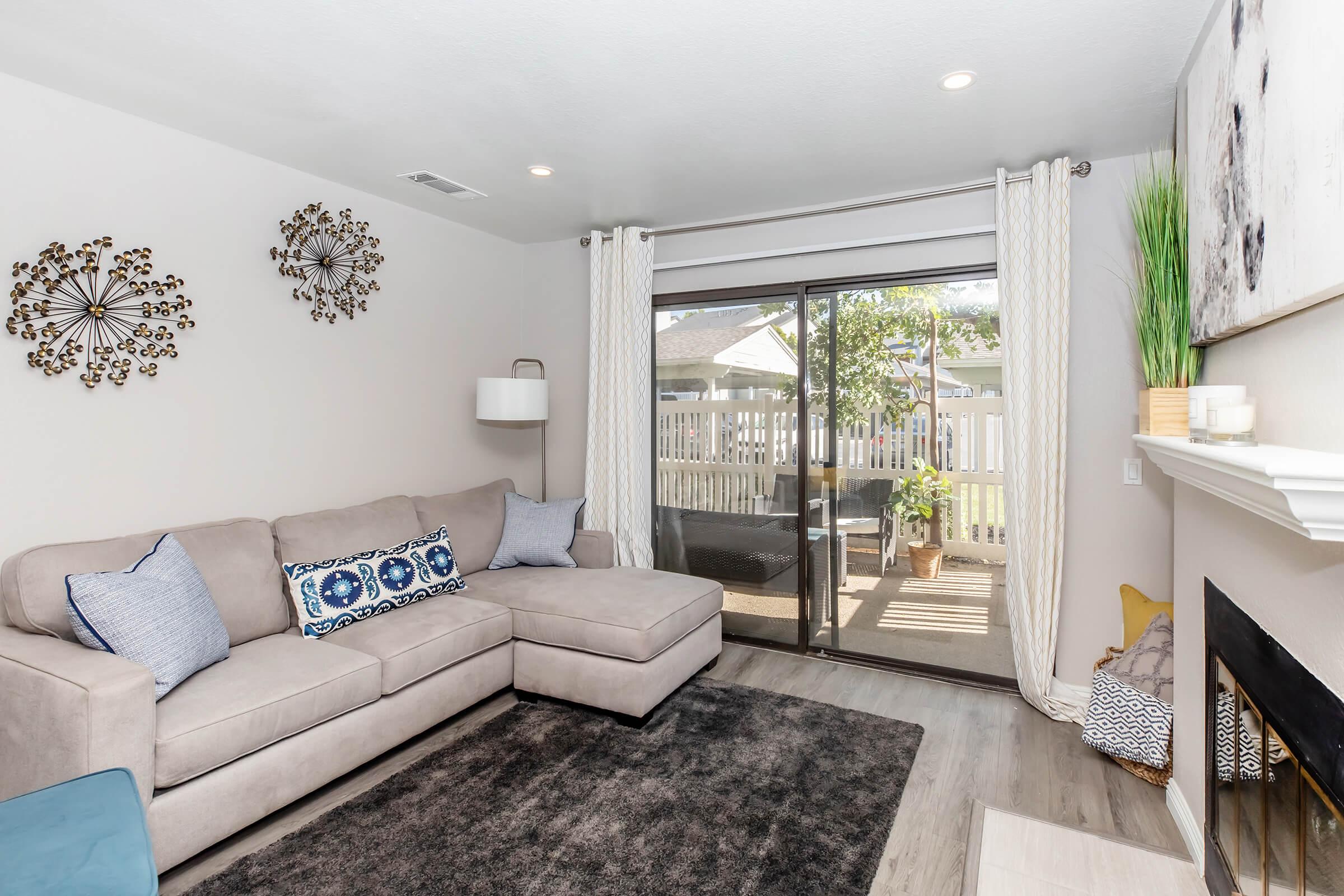 a living room filled with furniture and a large window