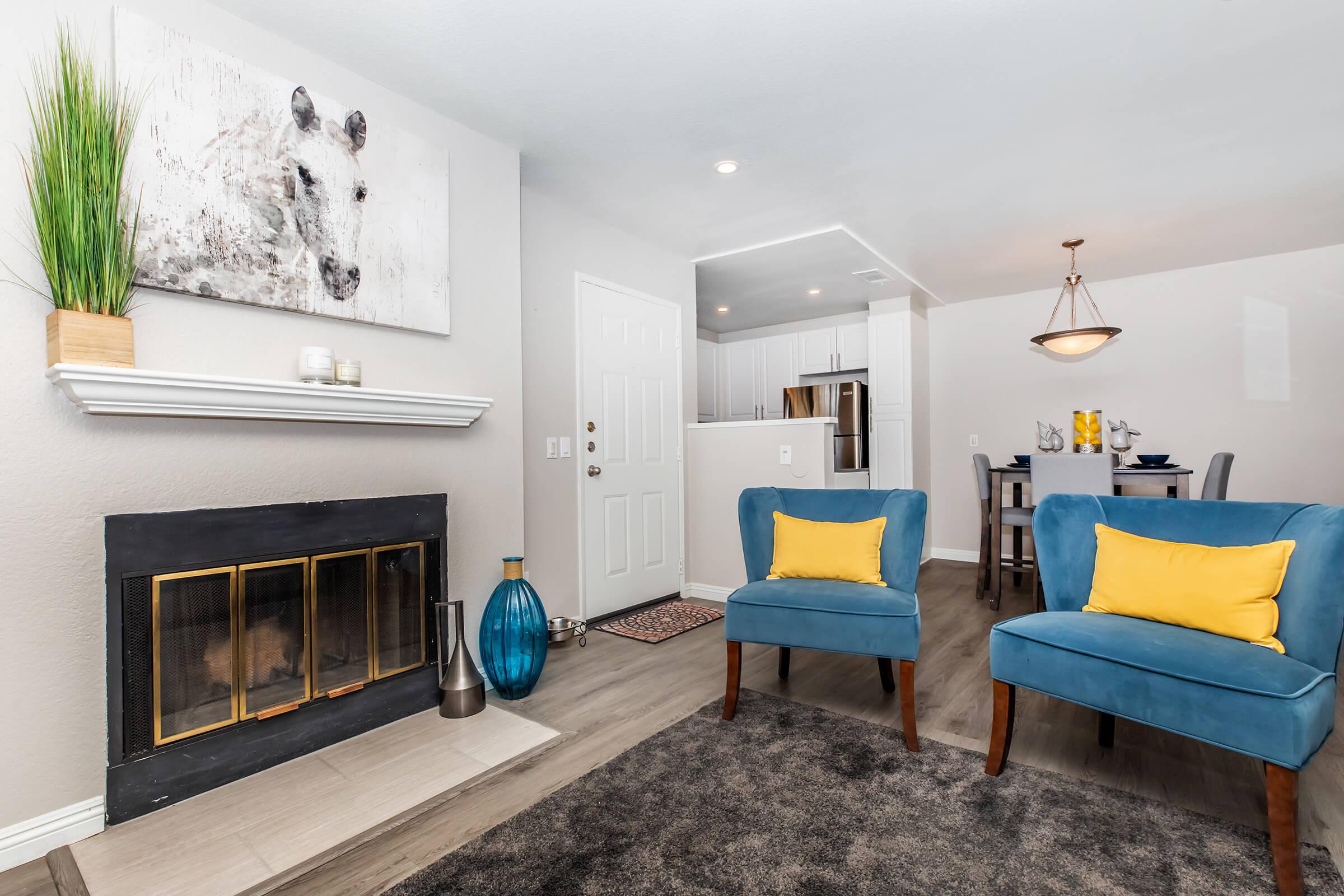 a living room filled with furniture and a blue chair