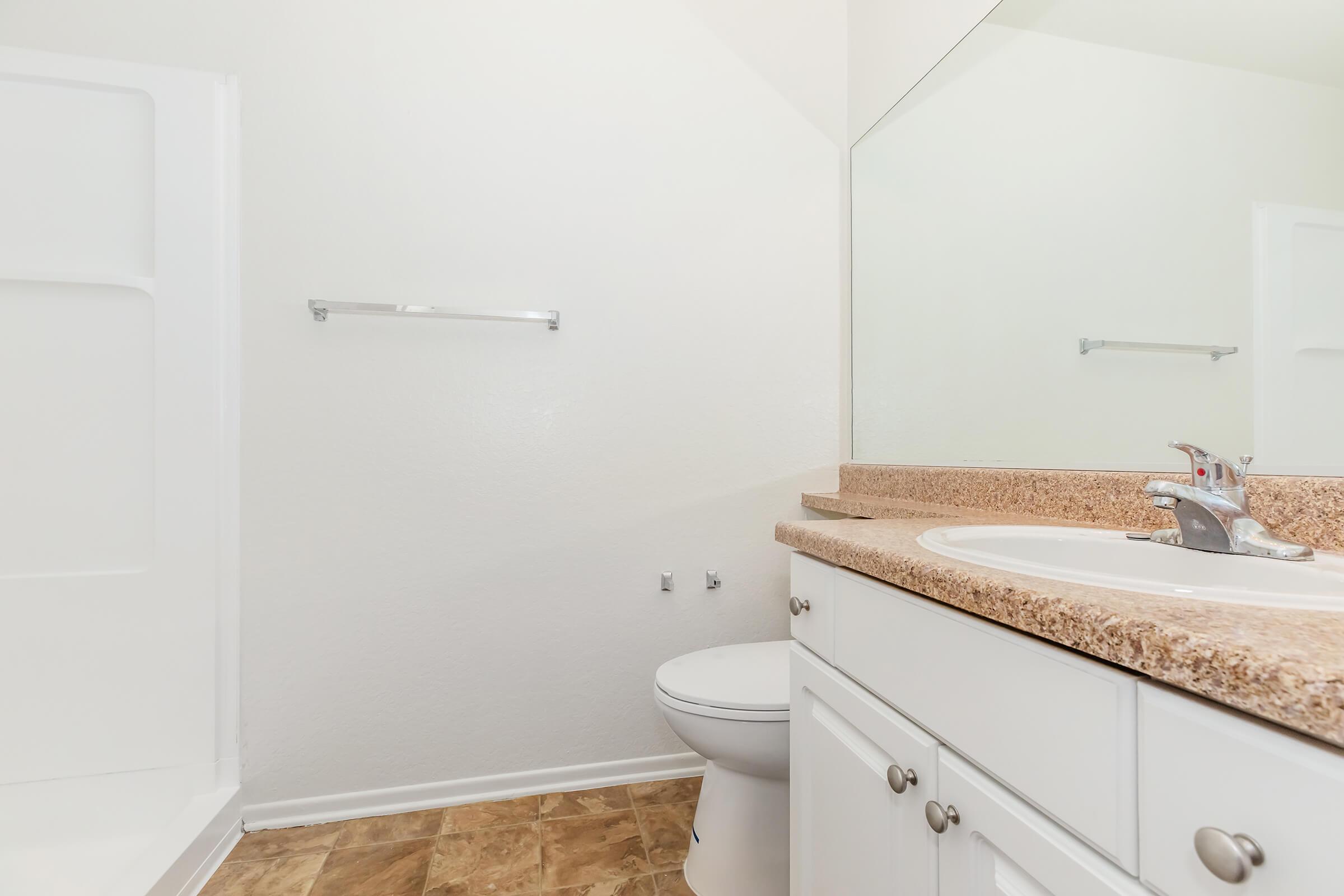 a kitchen with a sink and a mirror