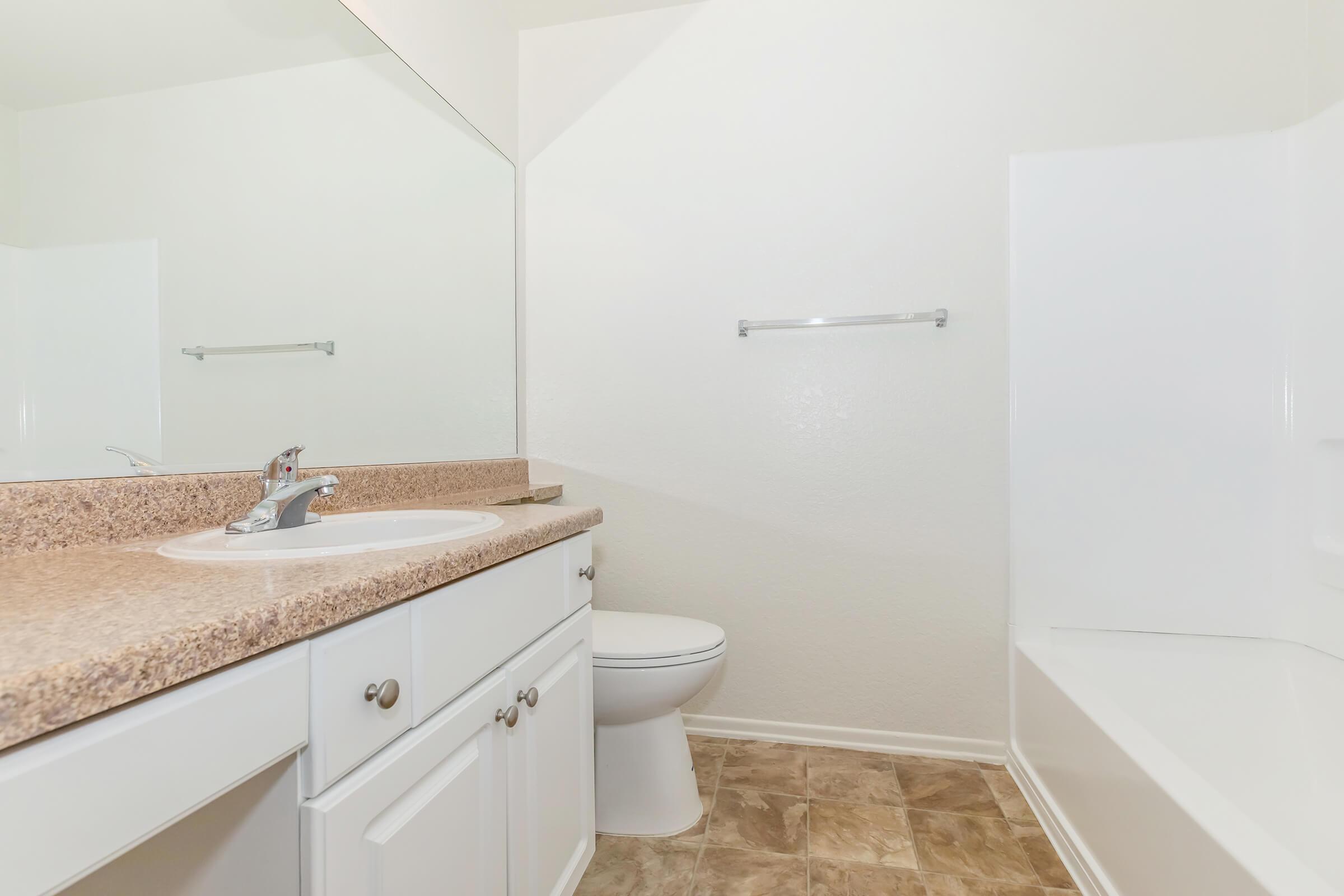 a kitchen with a sink and a mirror