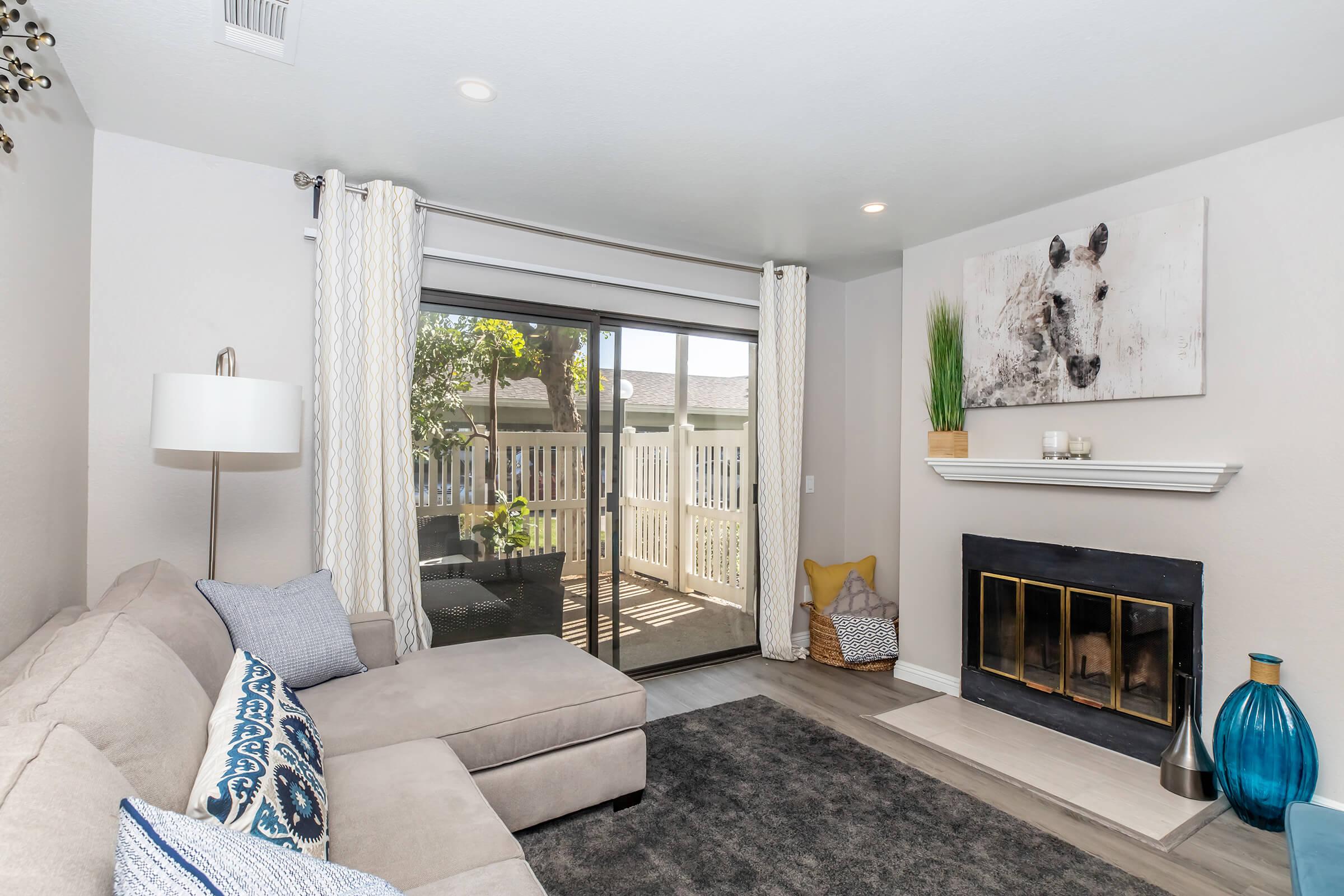 Two Bedroom Apartments in Redlands CA - Parkview Terrace - Spacious Living Room, with Fireplace, Large Sliding Glass Door to Private Patio, and Wood-Like Flooring