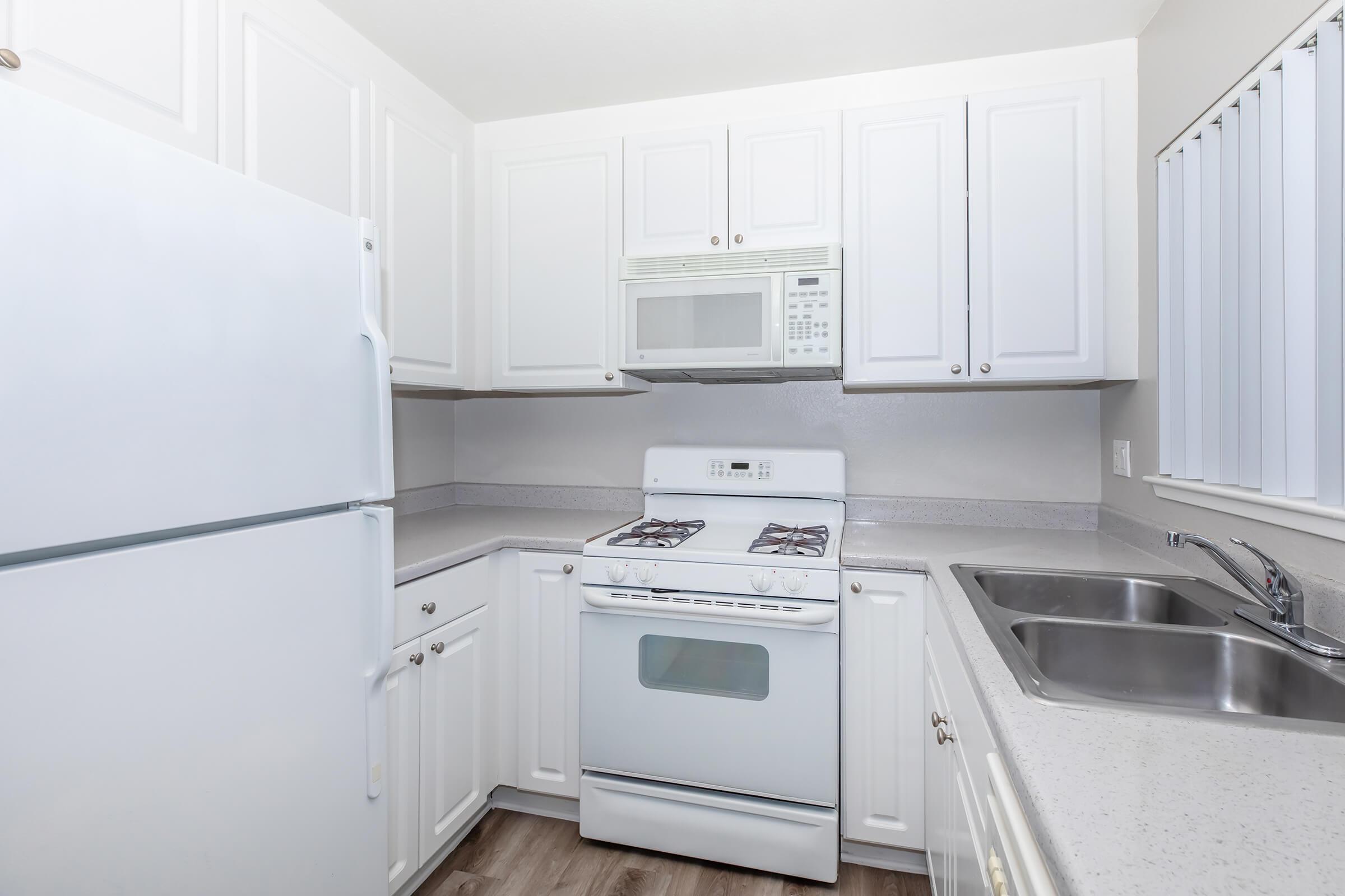 a kitchen with a stove and a refrigerator