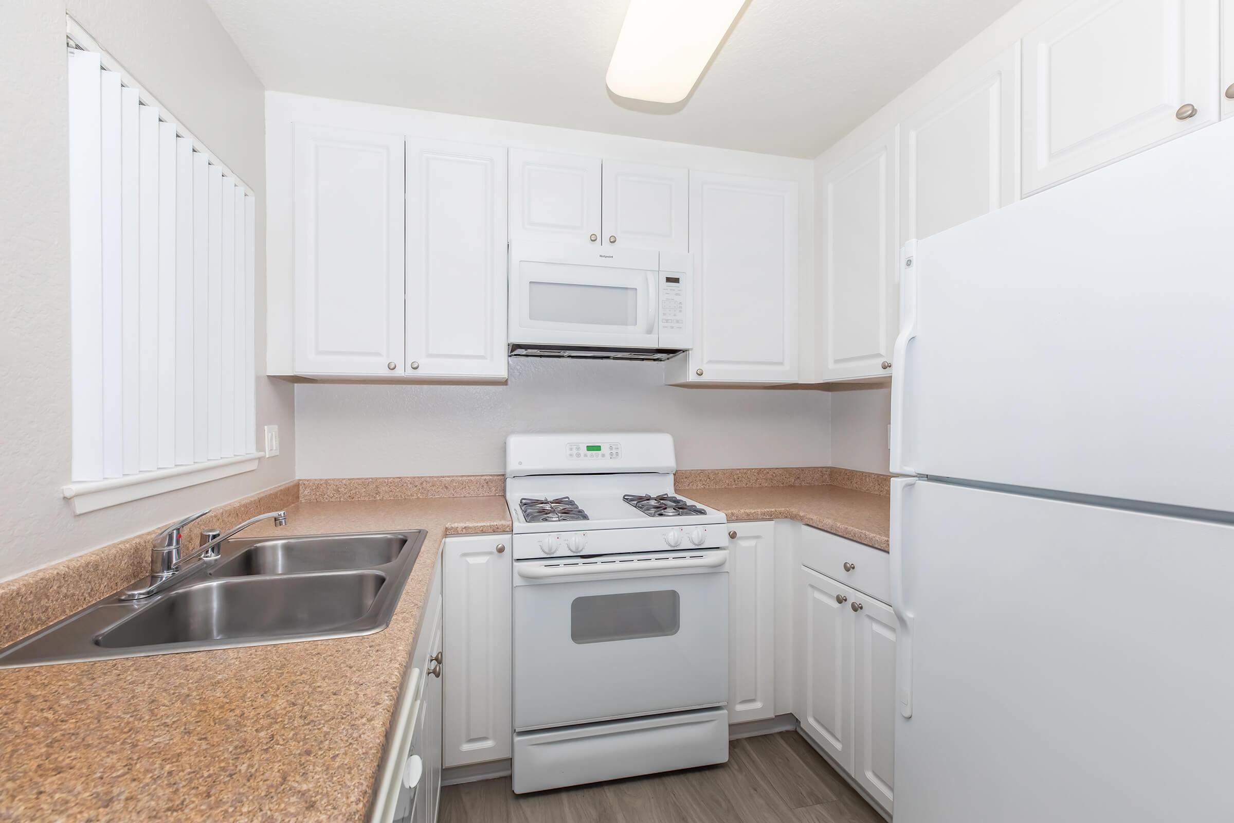 a kitchen with a stove and a refrigerator