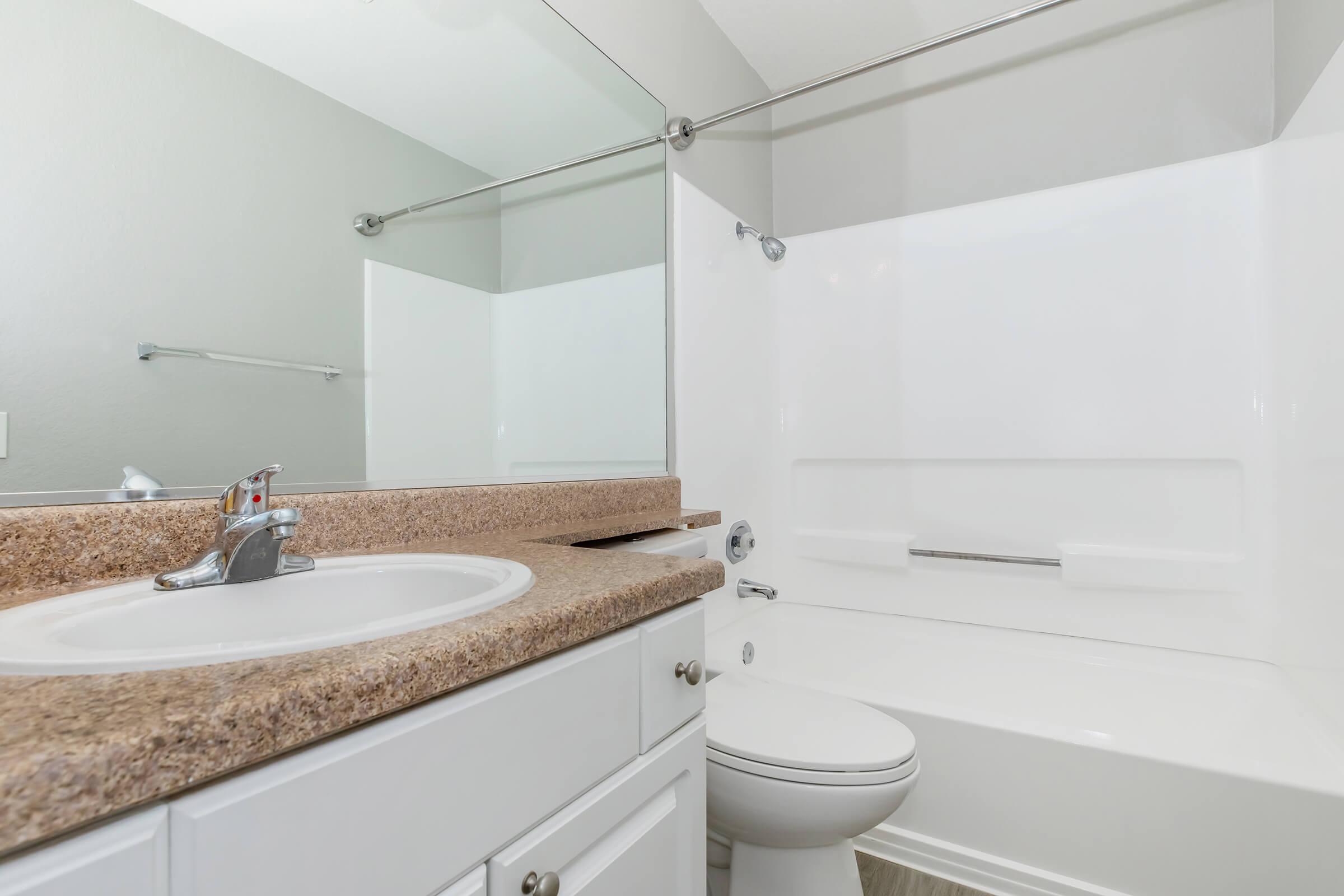 a kitchen with a sink and a mirror