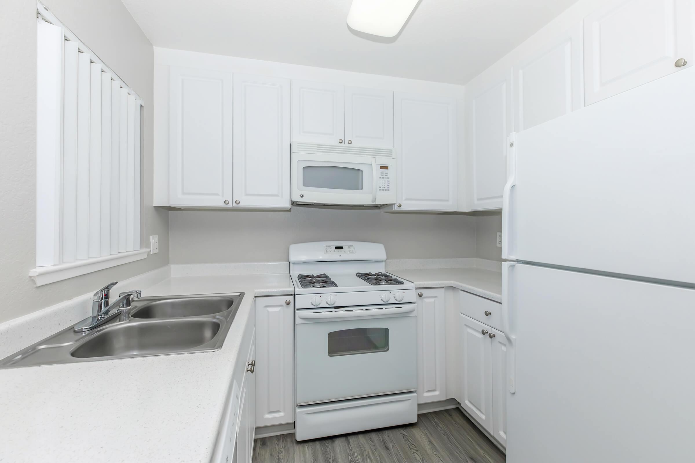 a kitchen with a stove and a refrigerator