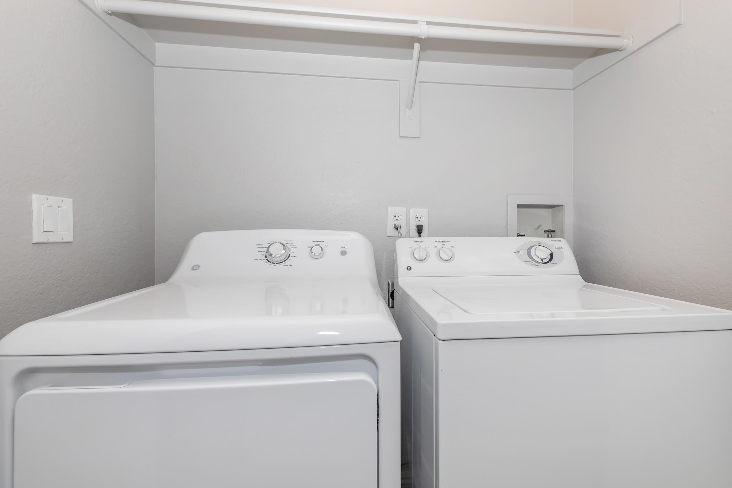 a microwave oven sitting on top of a refrigerator