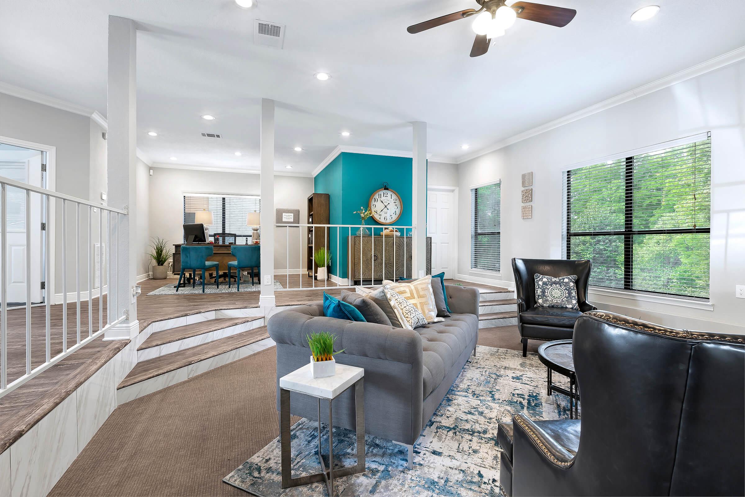 a living room filled with furniture and a large window