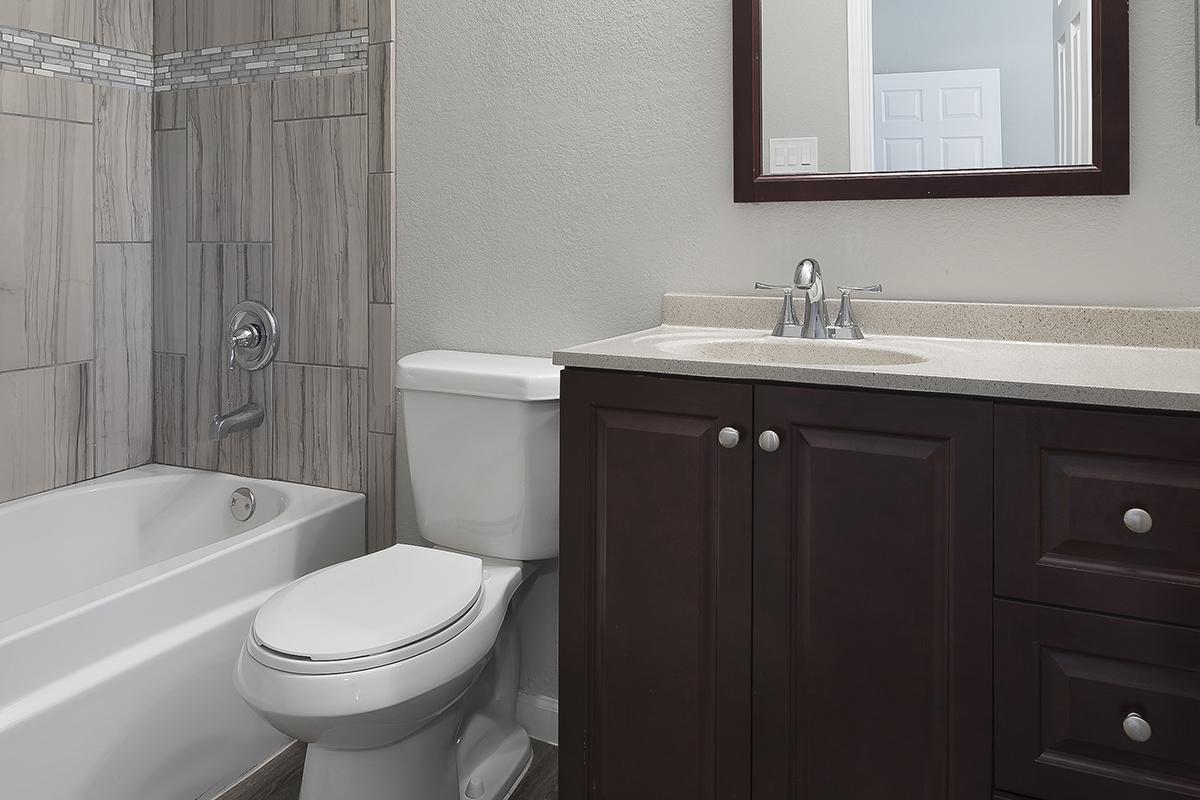 a large white tub sitting next to a sink