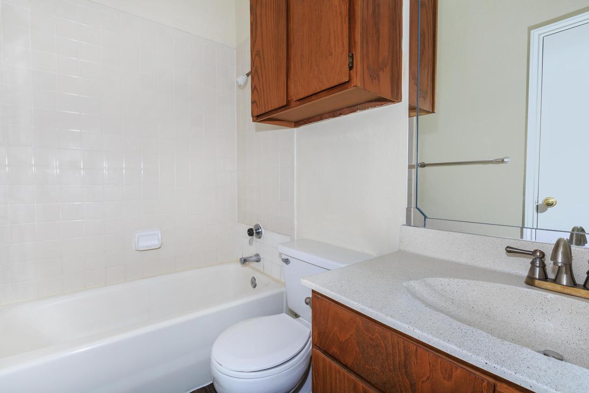 a white tub sitting next to a sink