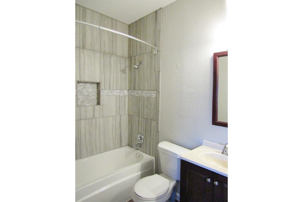 a white tub sitting next to a shower