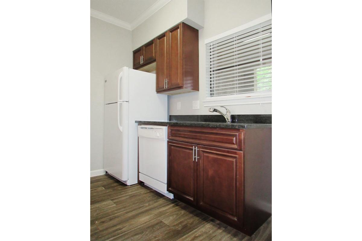 a kitchen with wooden cabinets and a refrigerator