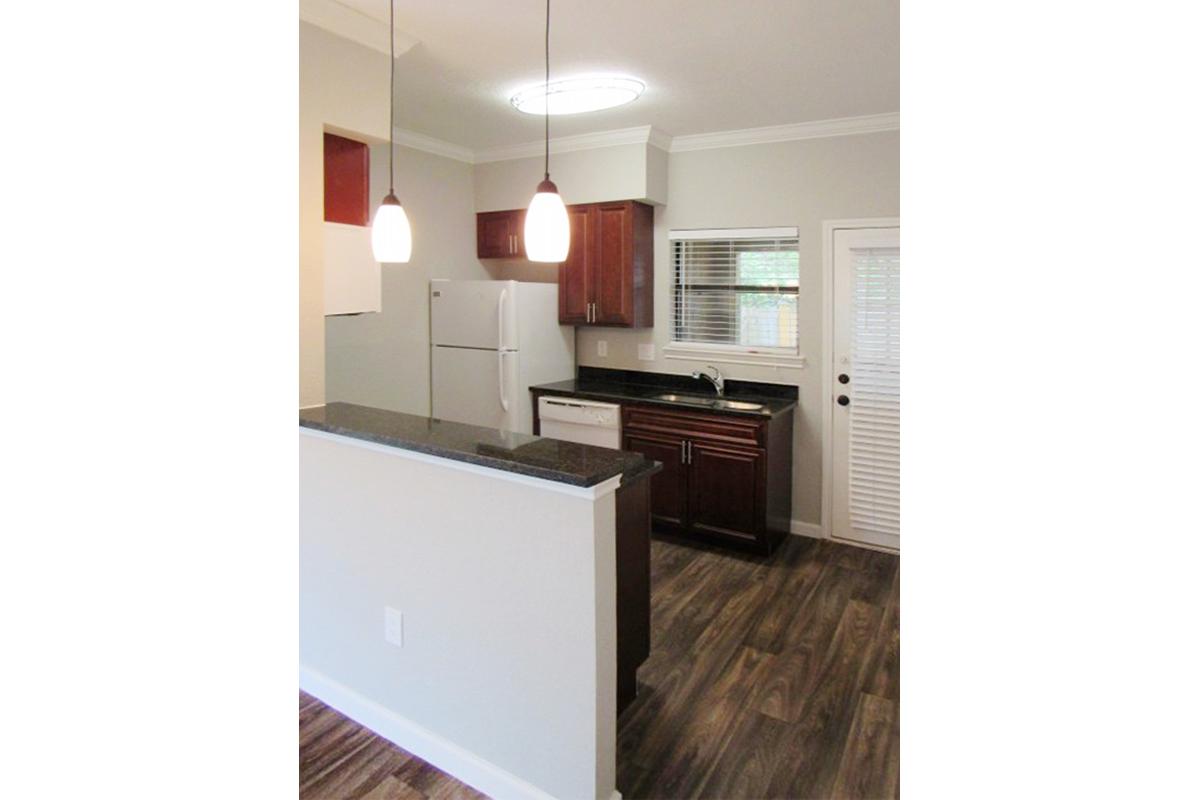 a kitchen with white appliances and wooden cabinets