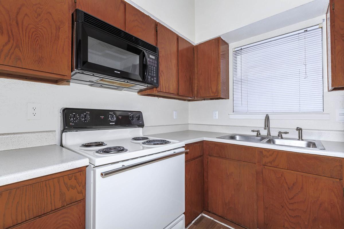 a stove top oven sitting inside of a kitchen