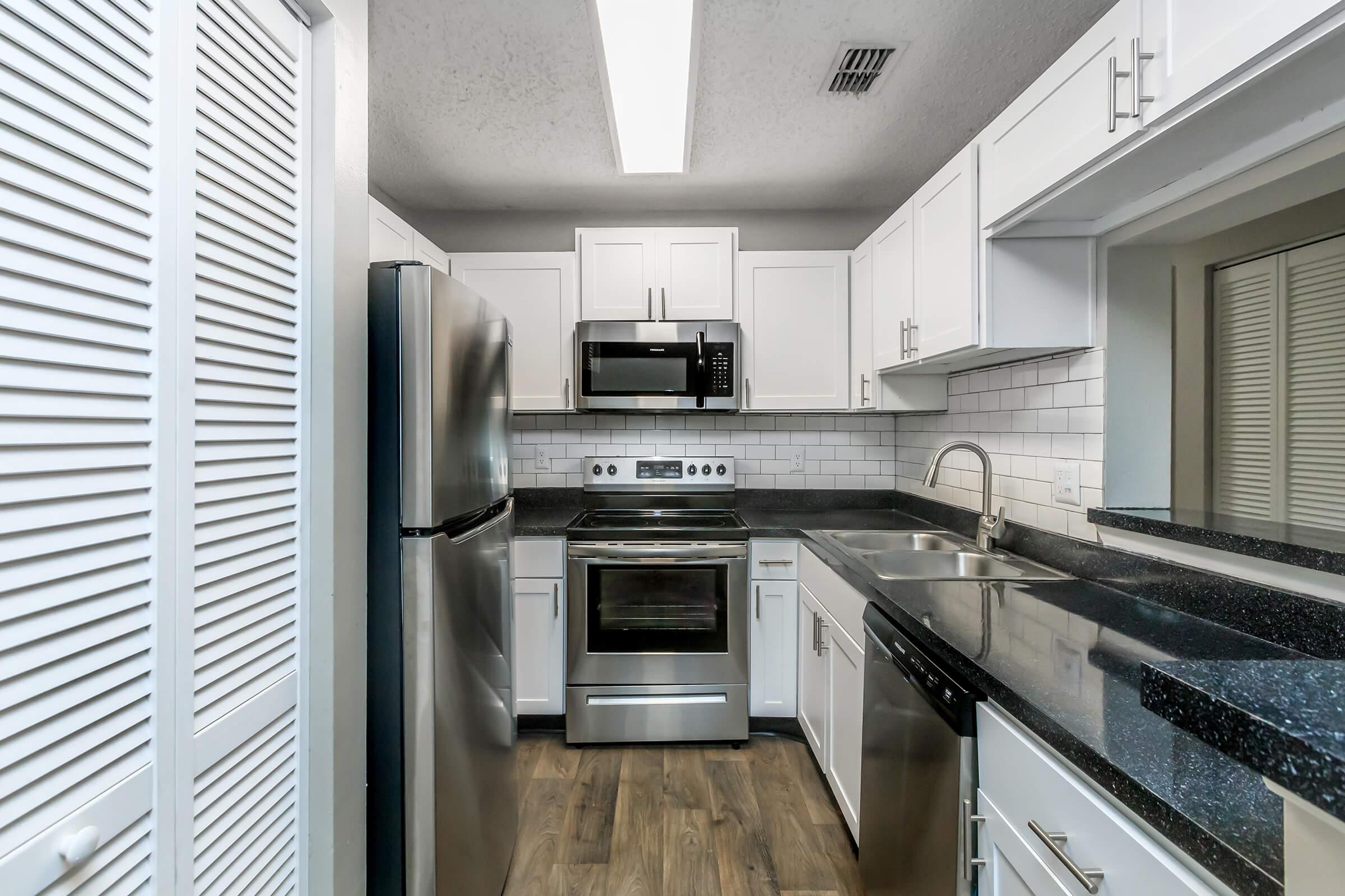 a large kitchen with stainless steel appliances