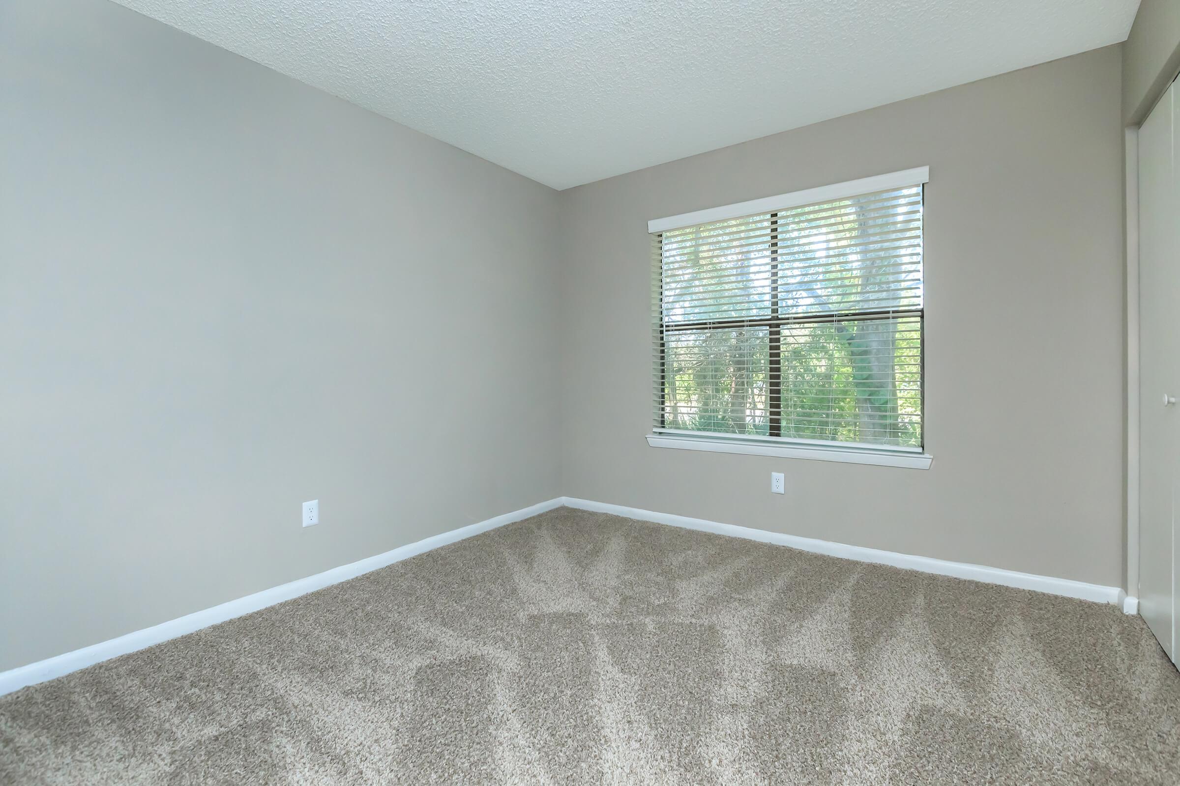 a bedroom with a large window