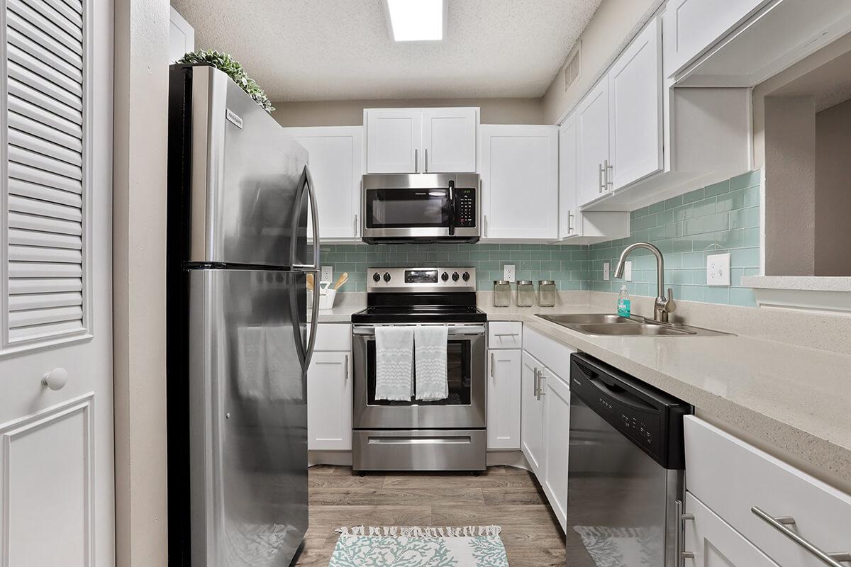 a kitchen with a stove sink and refrigerator