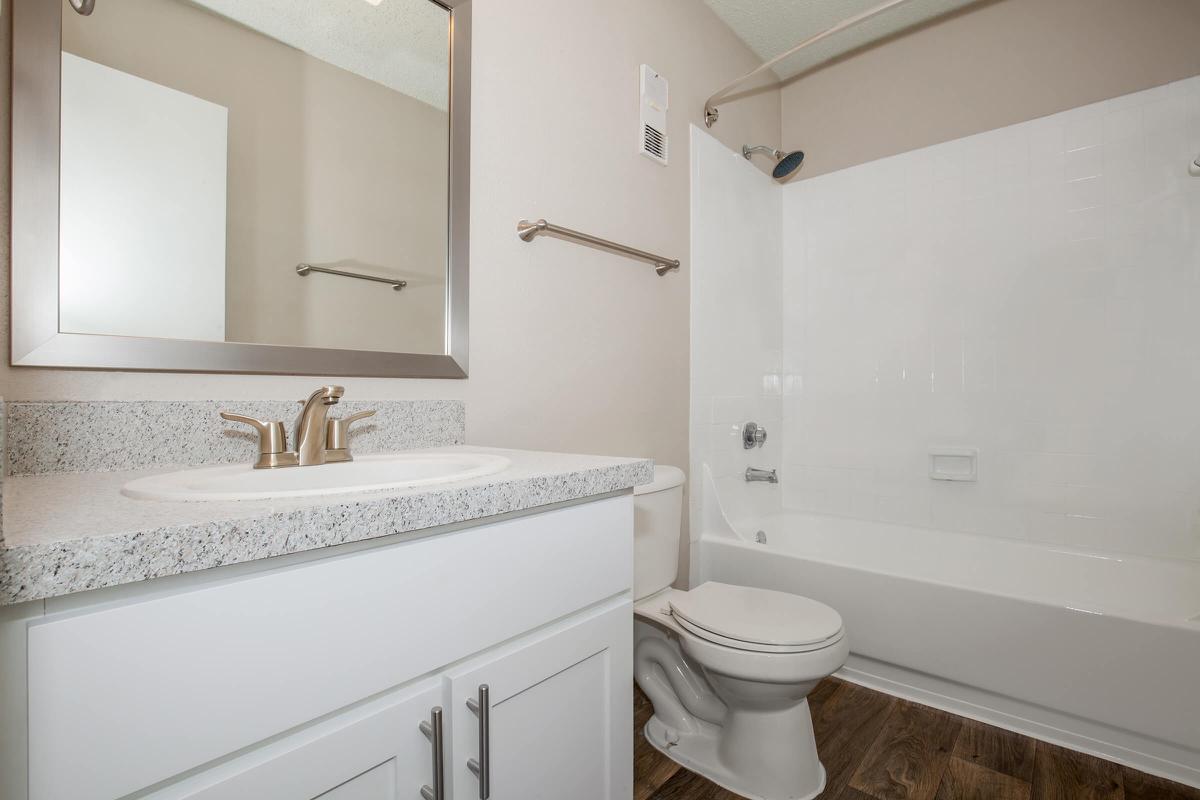 a white tub sitting next to a sink