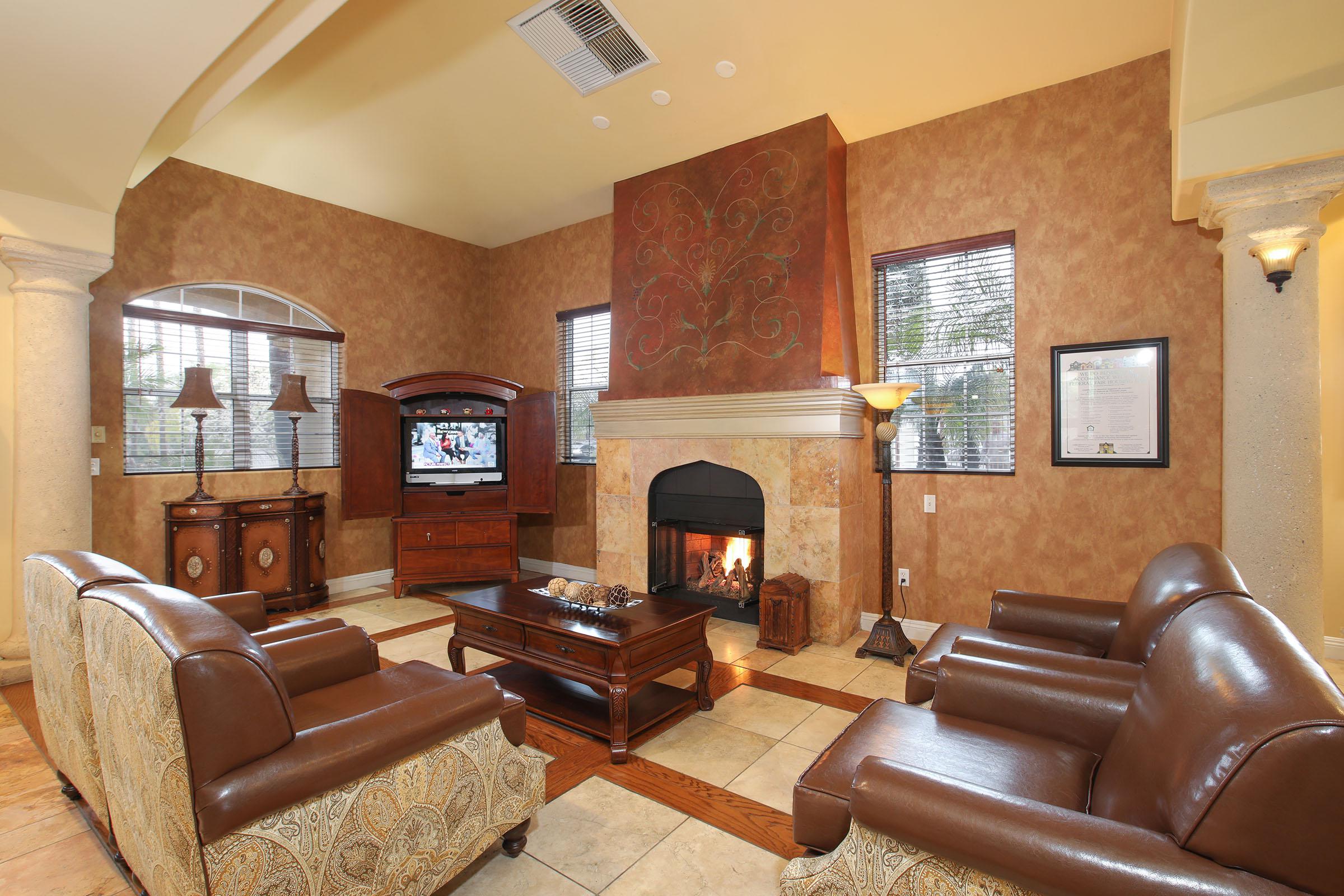 a living room filled with furniture and a fire place sitting in a chair