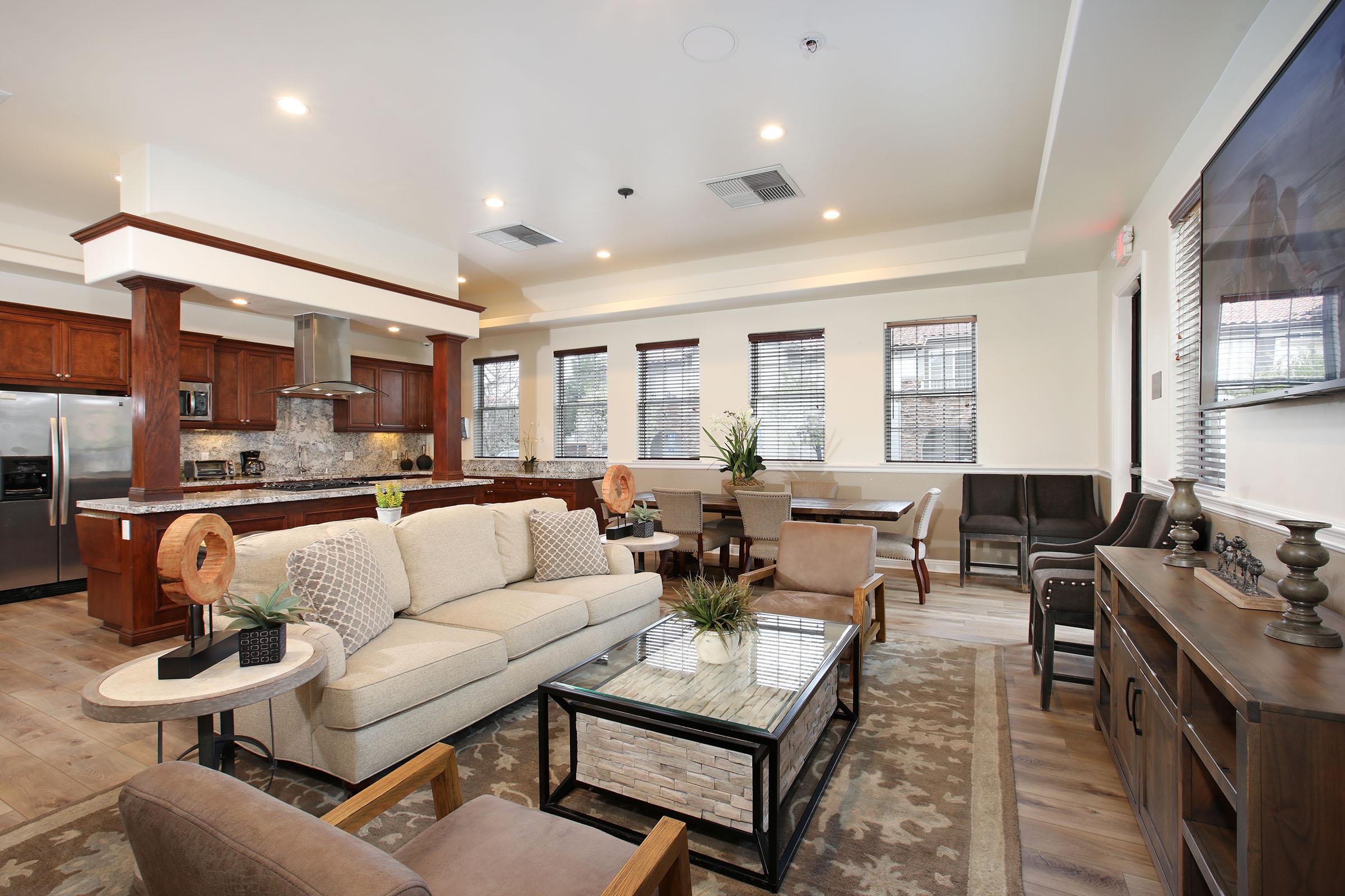 a living room filled with furniture and a large window