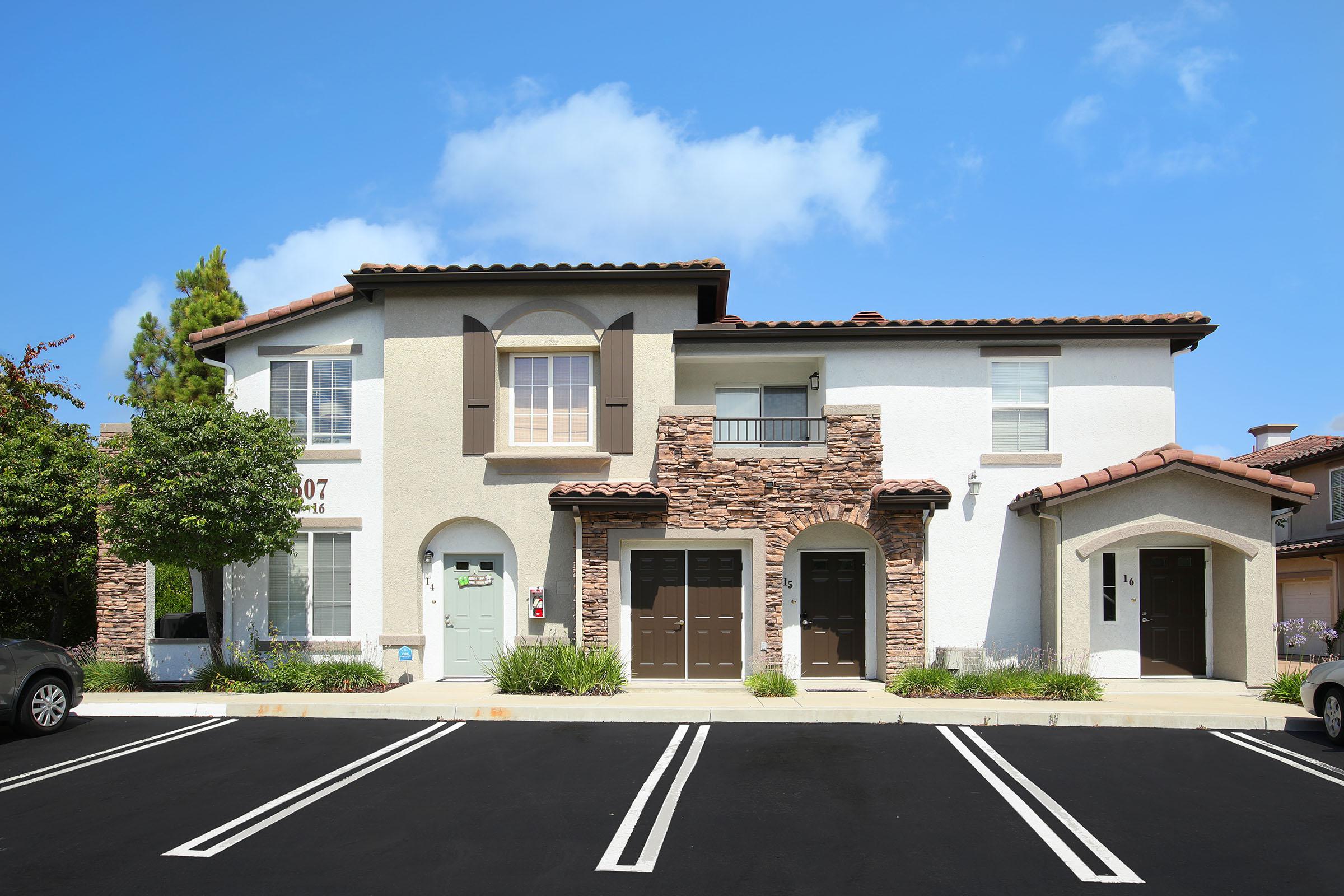 an empty parking lot in front of a house