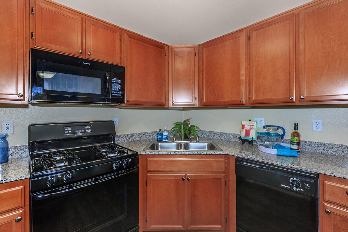 a kitchen with stainless steel appliances and wooden cabinets