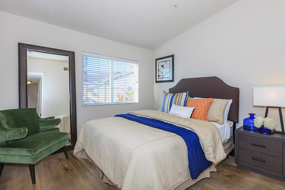 a bedroom with a bed and desk in a room