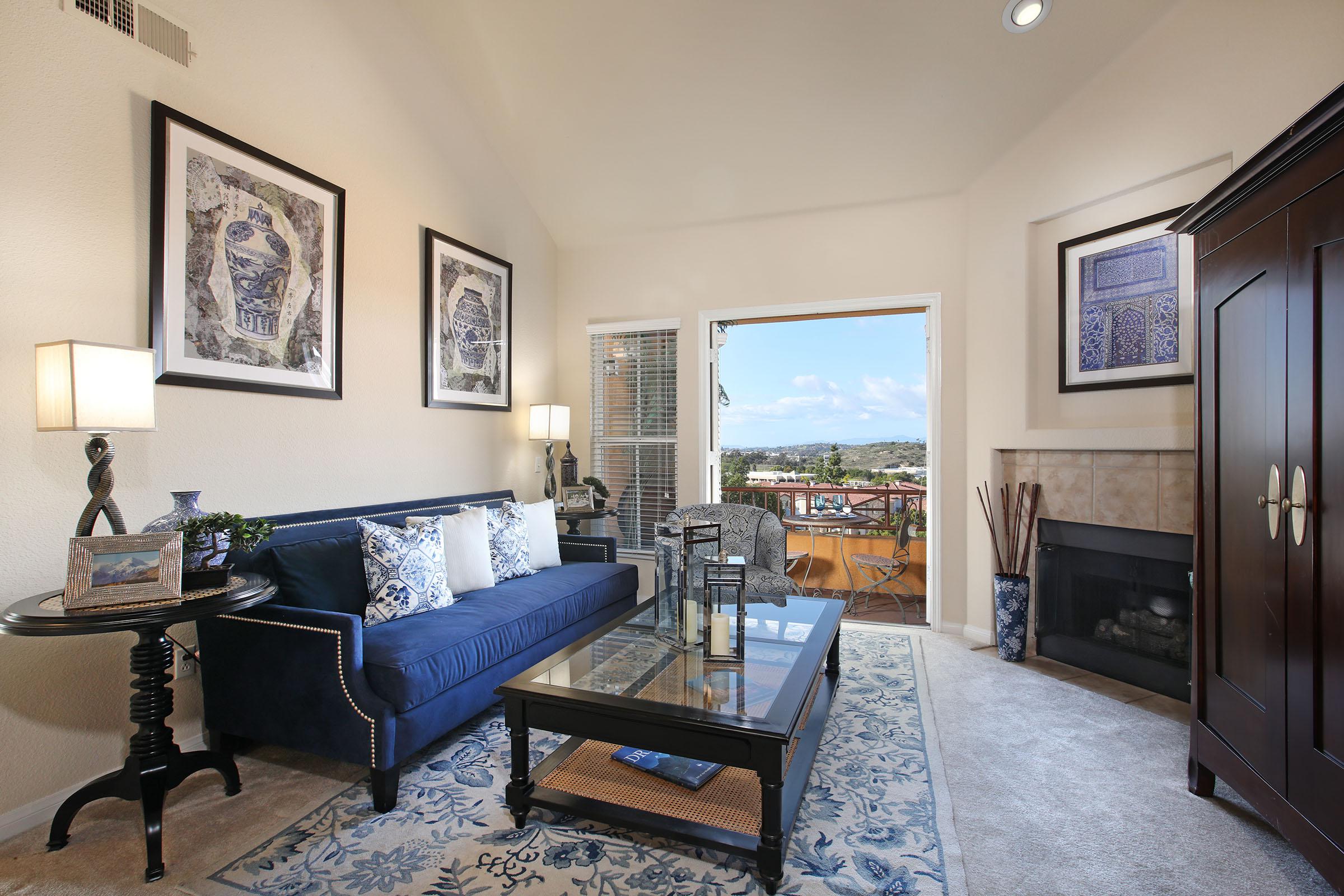 a living room filled with furniture and a large window