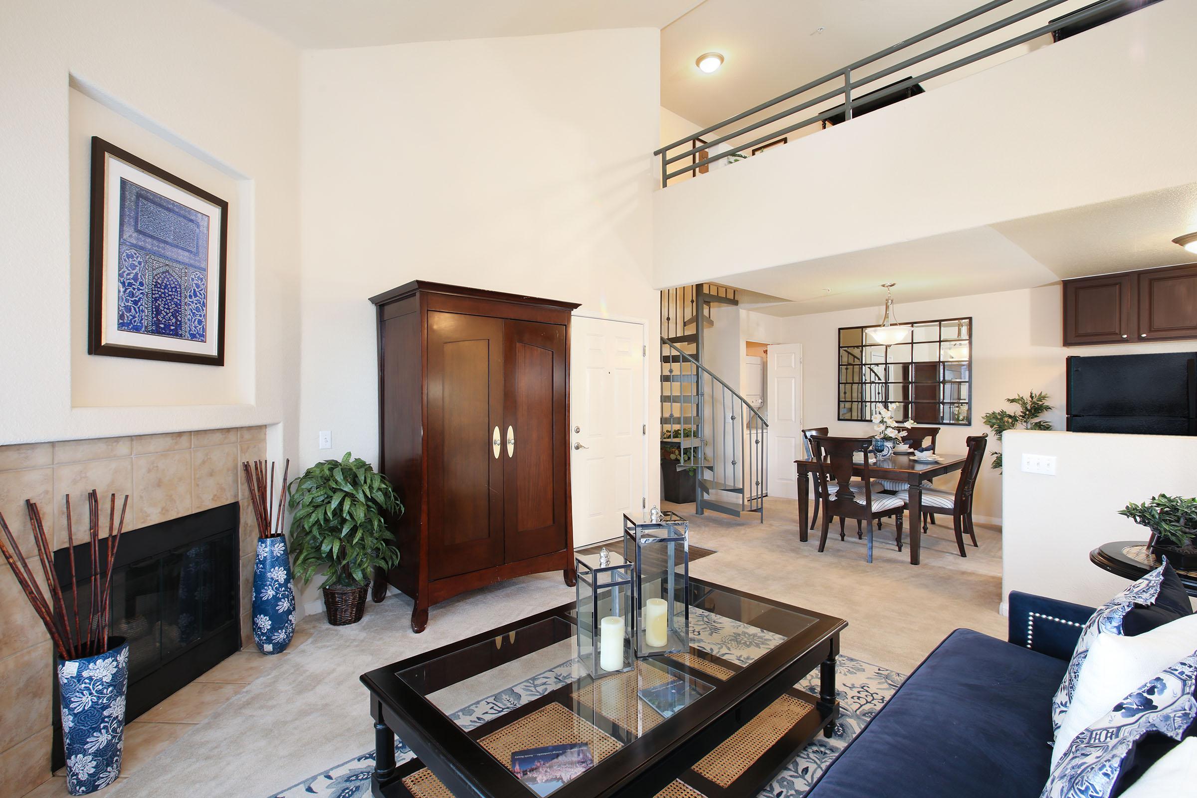 a living room filled with furniture and a fireplace