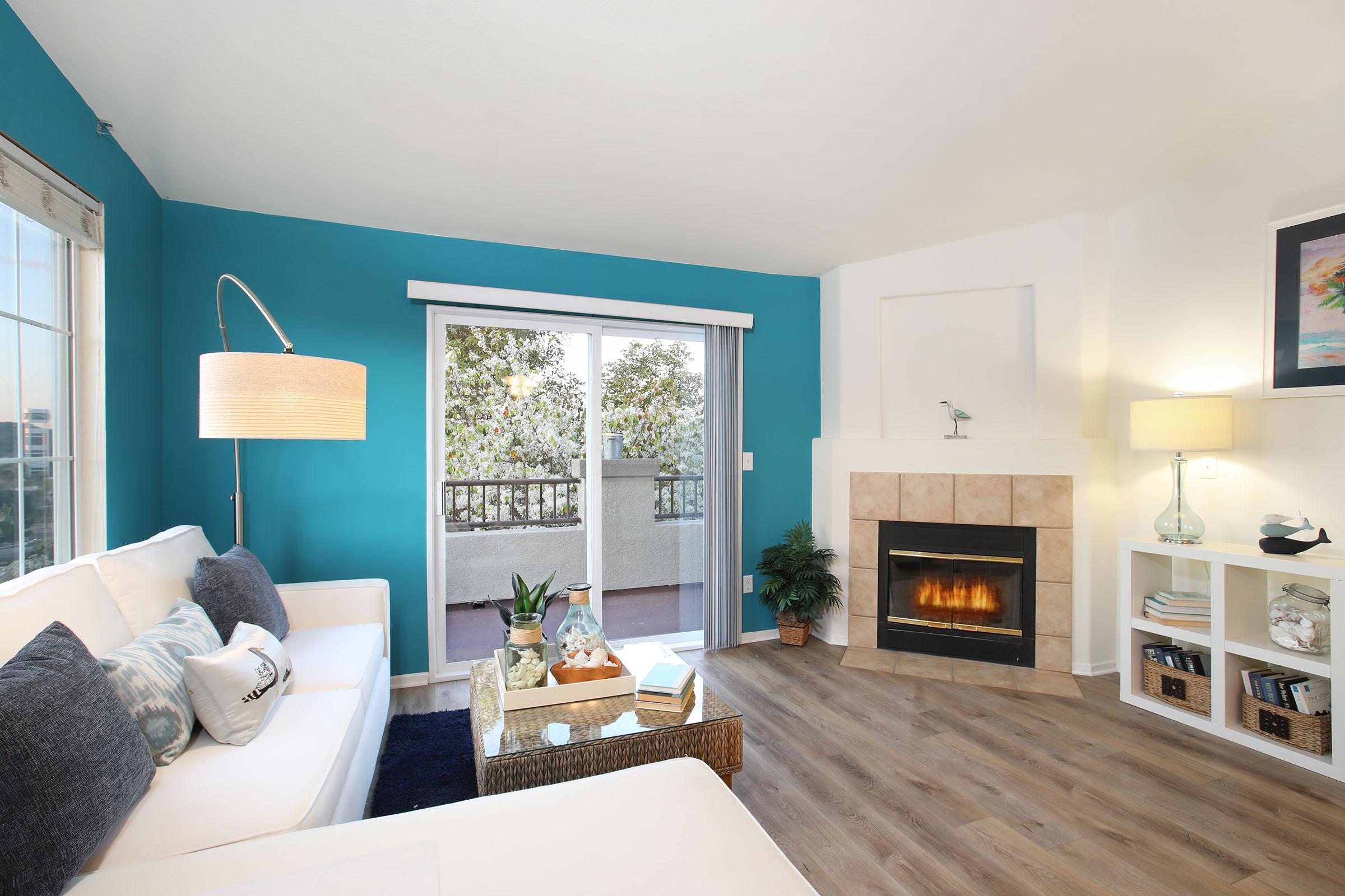 a living room filled with furniture and a fire place