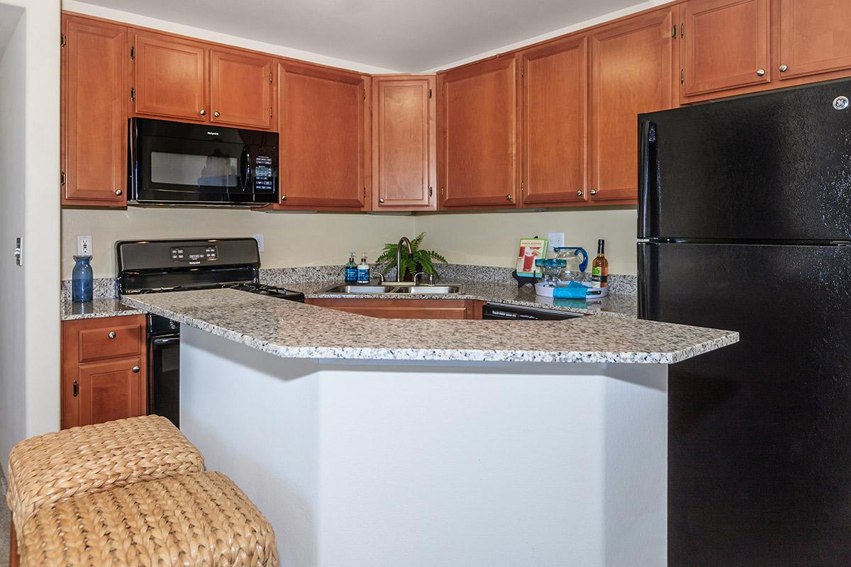 a modern kitchen with stainless steel appliances and wooden cabinets