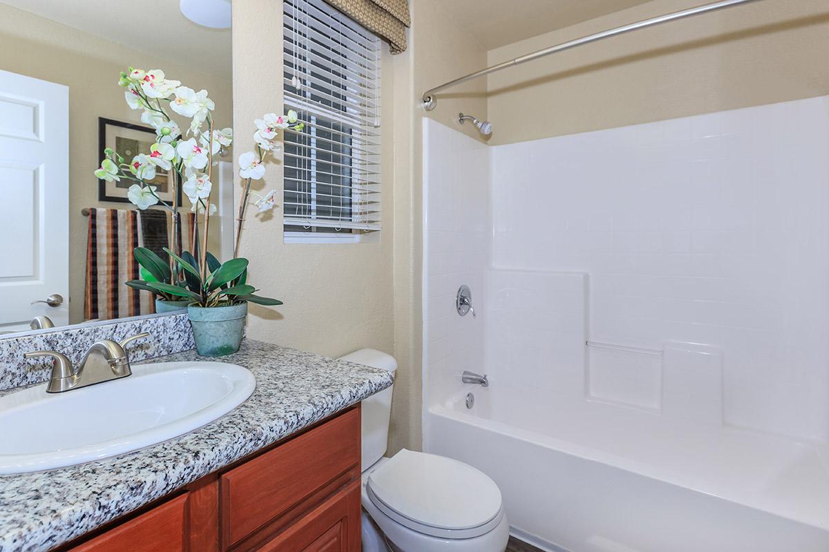 a large white tub next to a sink