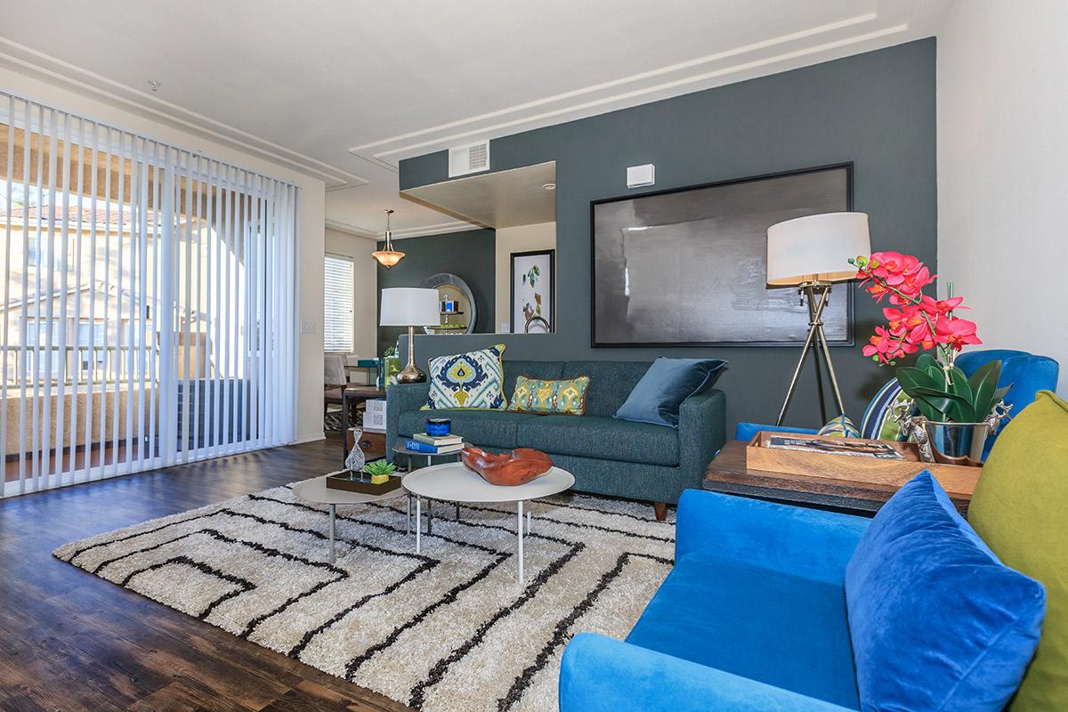 a living room filled with furniture and a large window