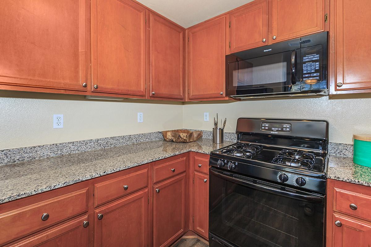 a kitchen with stainless steel appliances and wooden cabinets