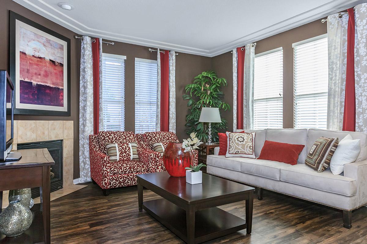 a living room filled with furniture and a large window