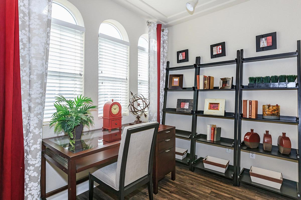 a living room filled with furniture and a large window