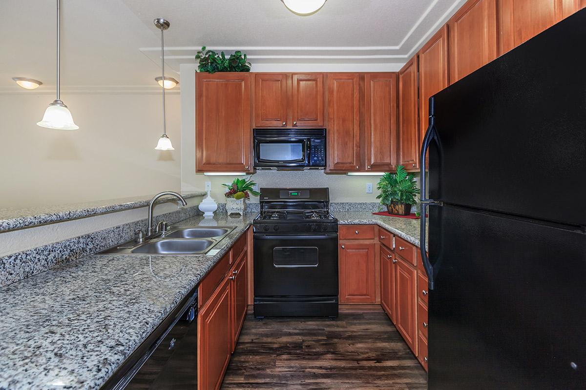 a kitchen with stainless steel appliances and wooden cabinets