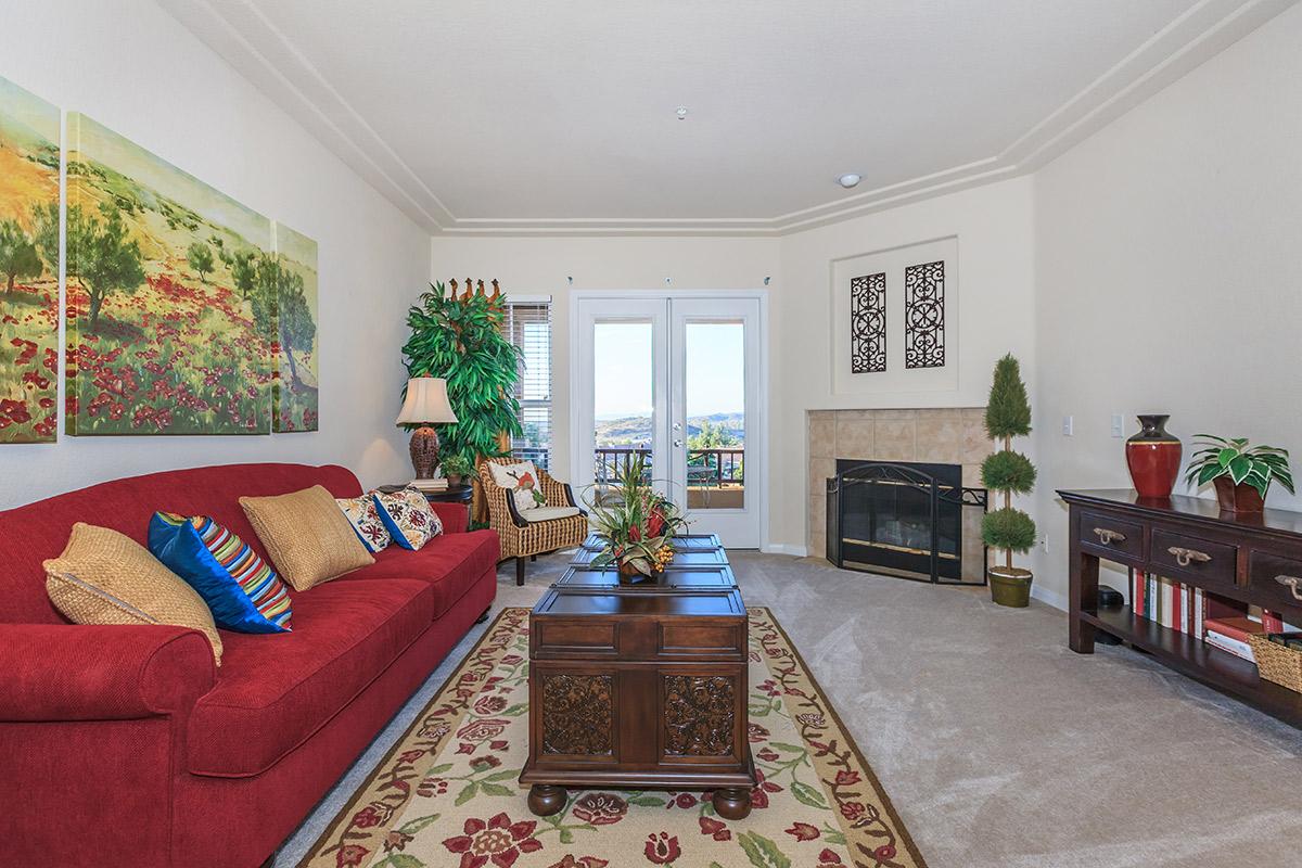 a living room filled with furniture and a large window