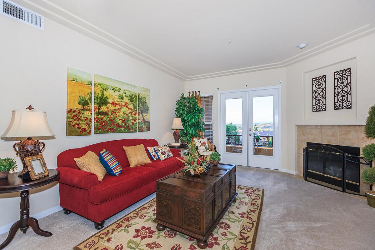 a living room filled with furniture and a fireplace