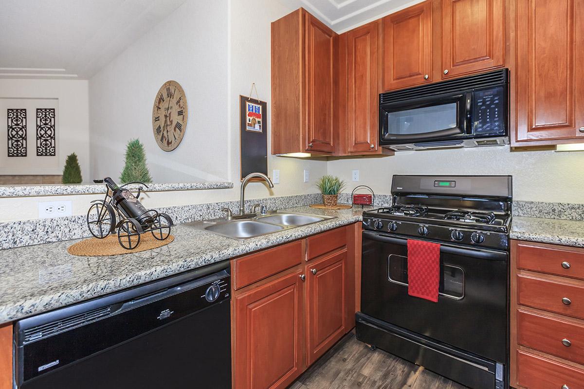 a kitchen with stainless steel appliances and wooden cabinets