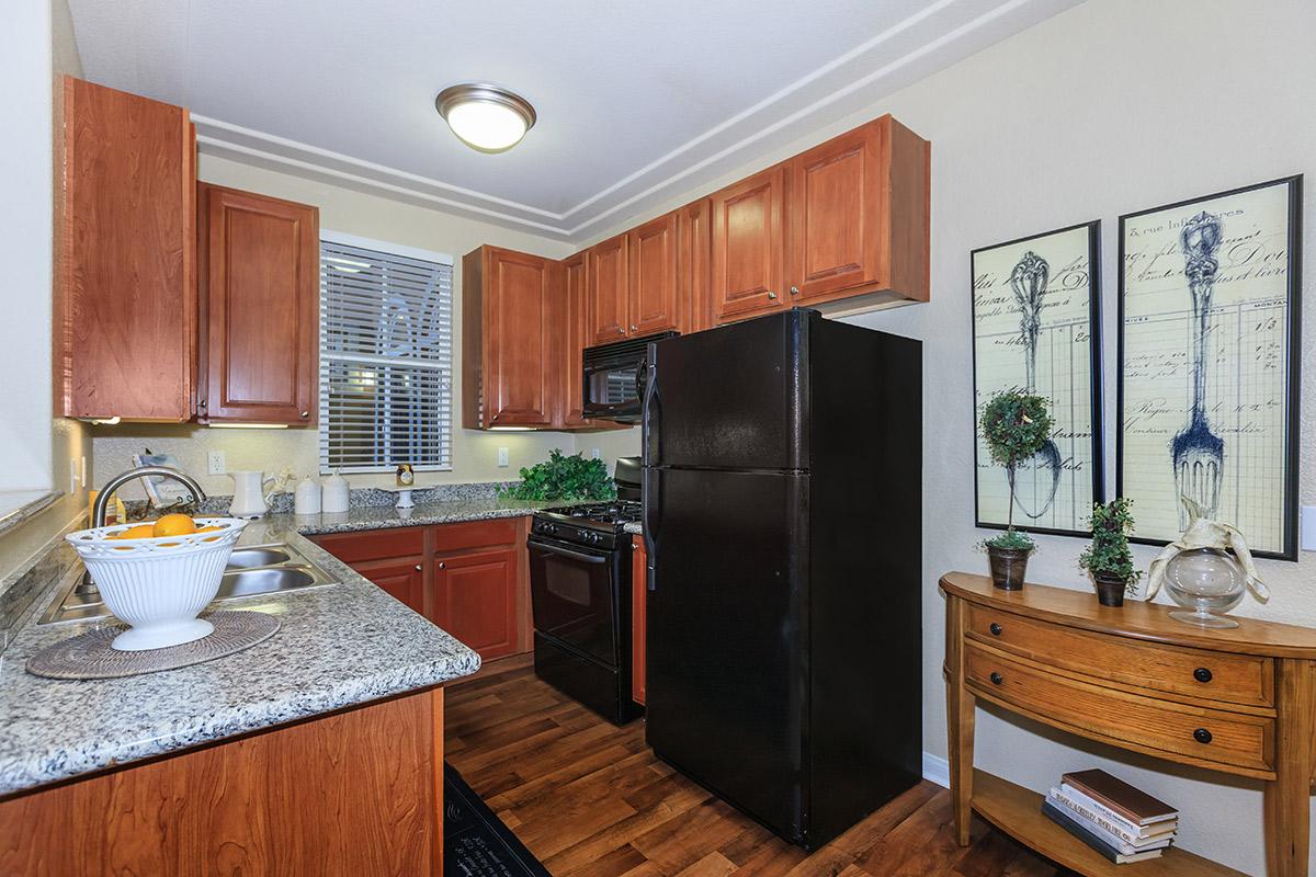 a modern kitchen with stainless steel appliances and wooden cabinets