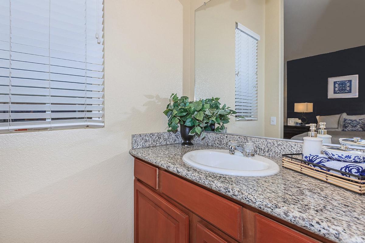 a white sink sitting under a window