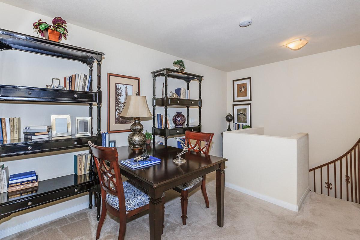 a living room filled with furniture and a tv