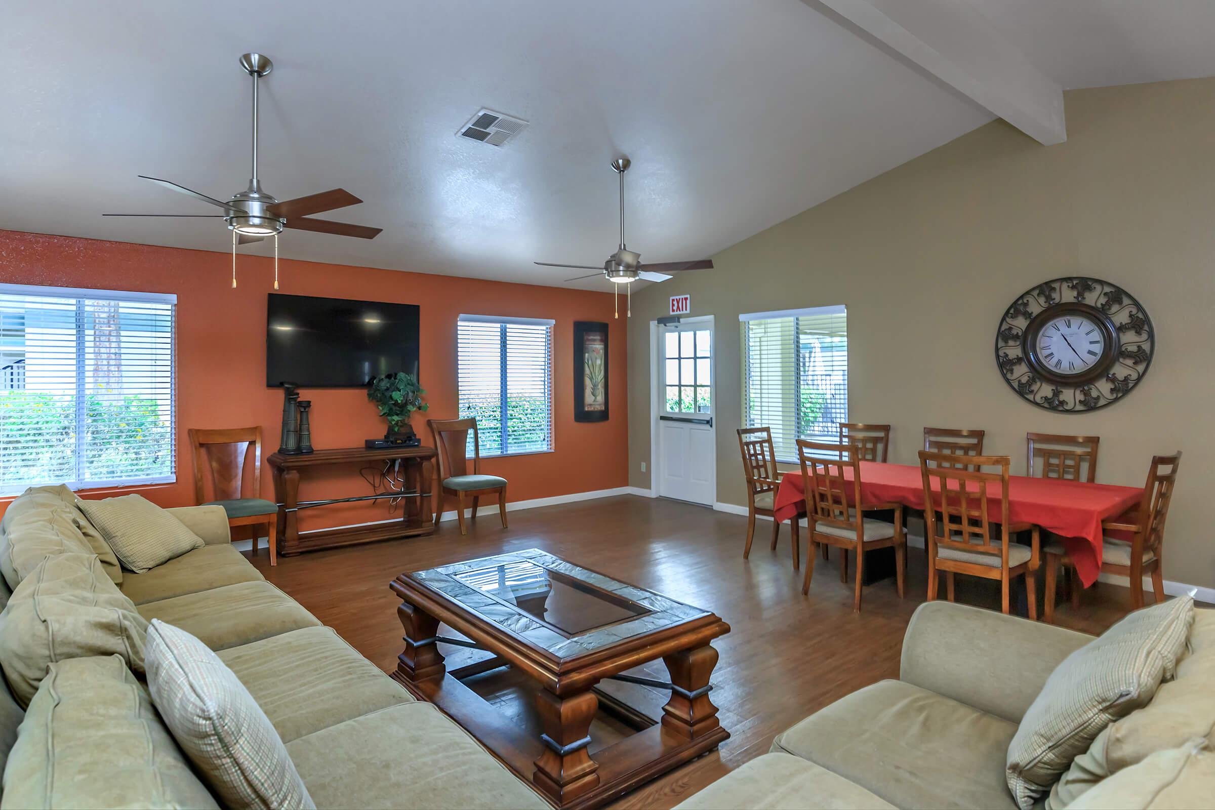 a living room filled with furniture and a flat screen tv