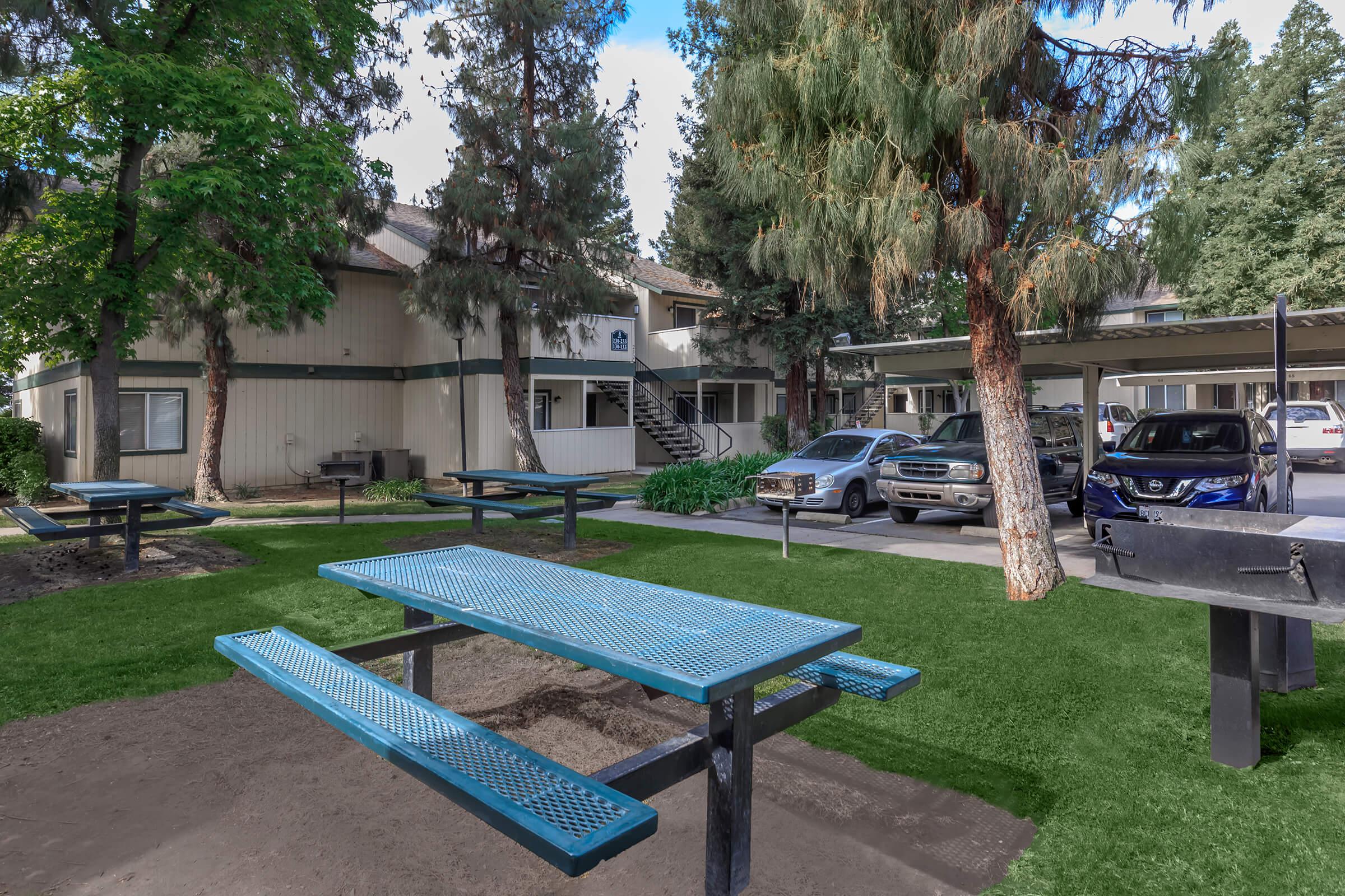 a couple of lawn chairs sitting on top of a bench in a park